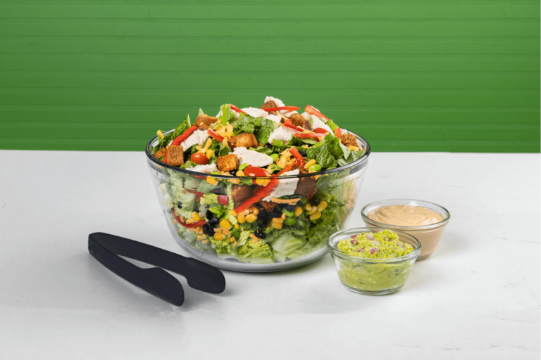 Photo of a bowl of salad and dressings.